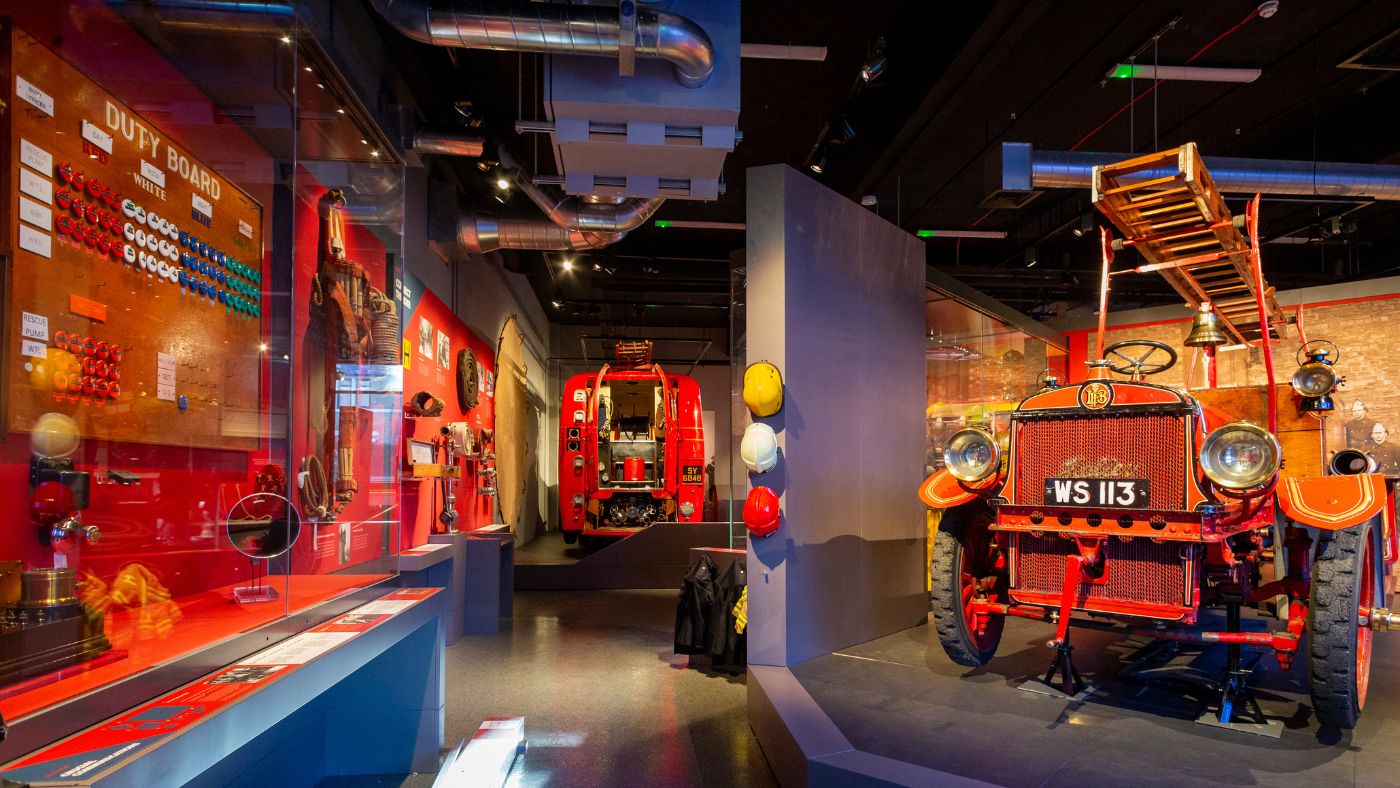 A museum with red antique fire appliances and firefighting equipment.