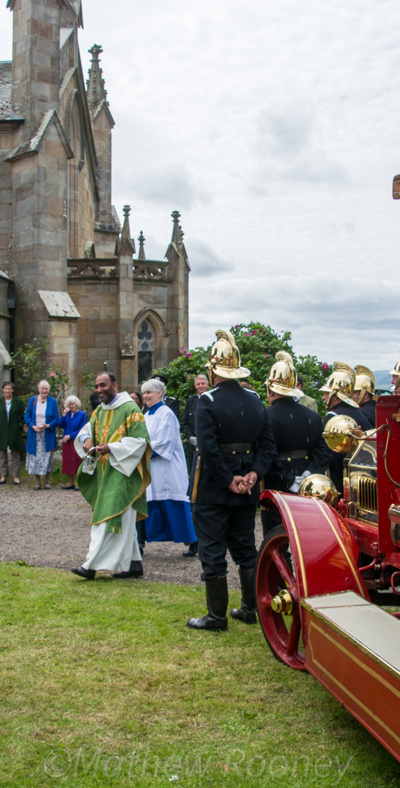 Churchgoers outside the church with Heritage Trust volunteers, a 1915 Dennis fire appliance and Scottish Fire and Rescue Service branded Land Rover Discovery