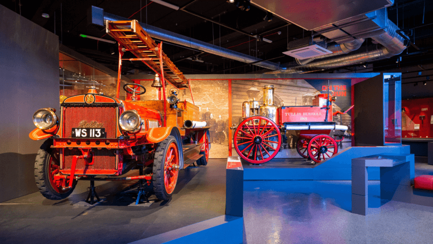 two very old fire engines painted bright red 