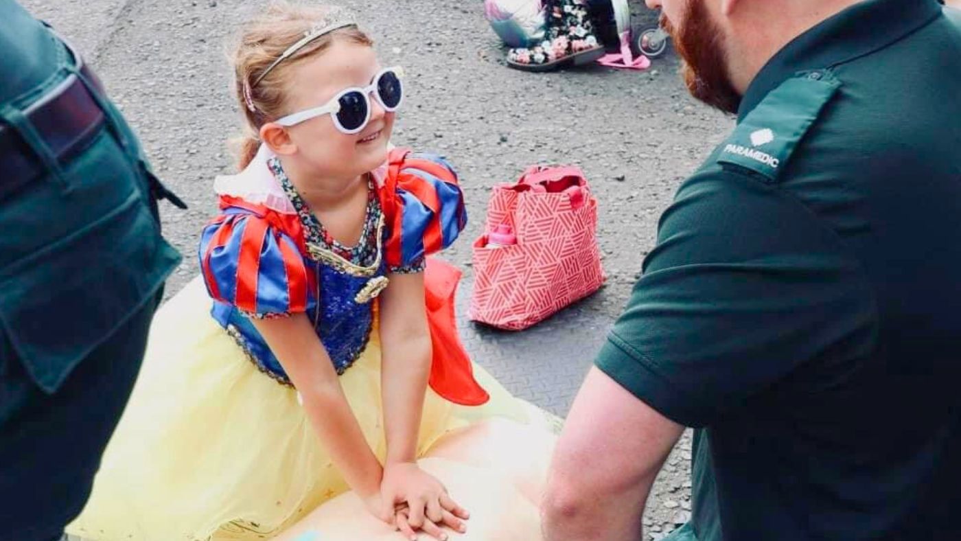 Nora, 5, learns first aid in her Snow White Killie Con costume.