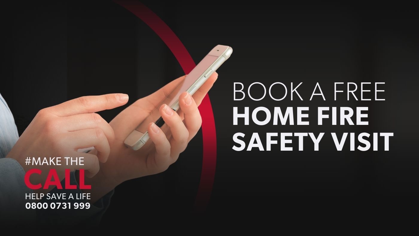 a hand is dialing a number into a mobile phone next to text that says Book a free home fire safety visit