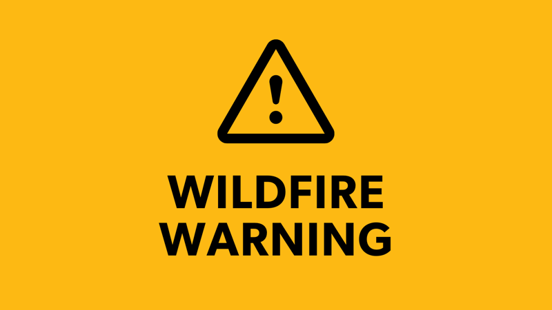 A warning symbol with theWildfire Warning text